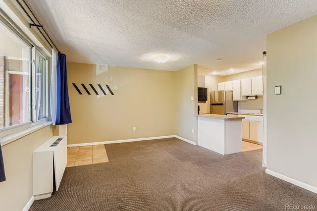 a view of a kitchen with a sink and cabinets