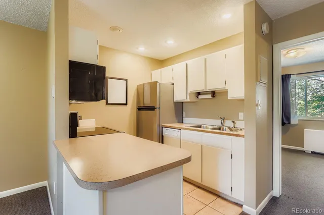 a kitchen with stainless steel appliances a refrigerator stove microwave and sink