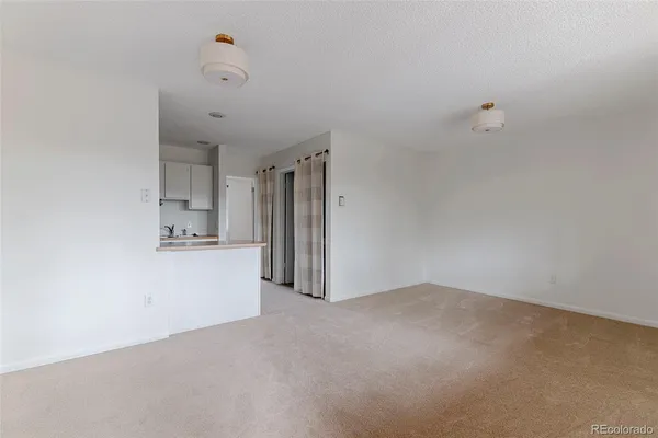 a kitchen with a sink a refrigerator and window