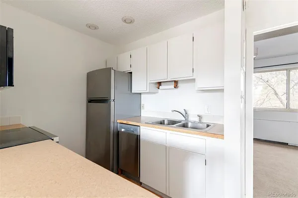 a kitchen with stainless steel appliances granite countertop a refrigerator stove and microwave