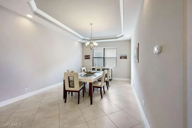 a dining room with a table and chairs