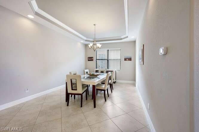 1641 Serrano Circle Naples, FL 34105 - Photo 15 of 50 a dining room with a table and chairs