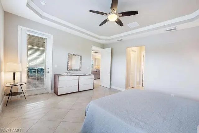 a spacious bedroom with a bed a couch and dresser