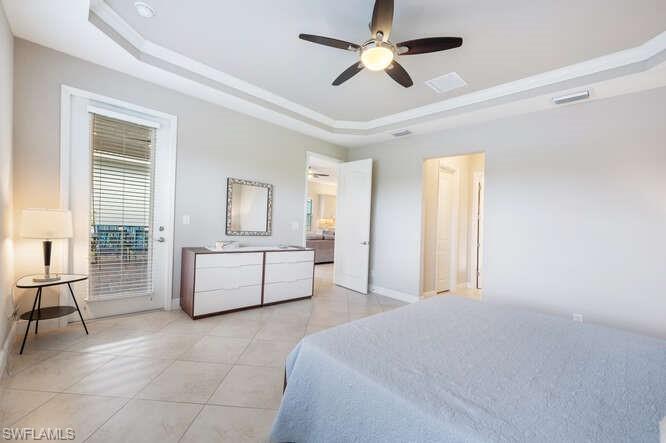 1641 Serrano Circle Naples, FL 34105 - Photo 24 of 50 a spacious bedroom with a bed a couch and dresser