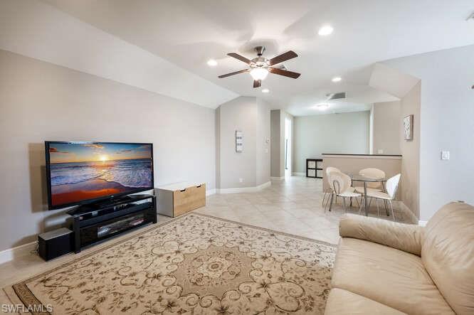 1641 Serrano Circle Naples, FL 34105 - Photo 32 of 50 a living room with furniture and a flat screen tv