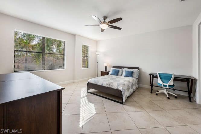 1641 Serrano Circle Naples, FL 34105 - Photo 36 of 50 a bedroom with a bed a table and a large window