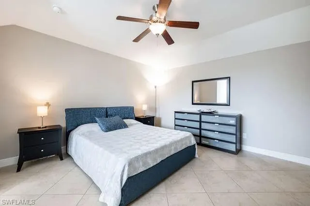 a bedroom with a bed and a night stand