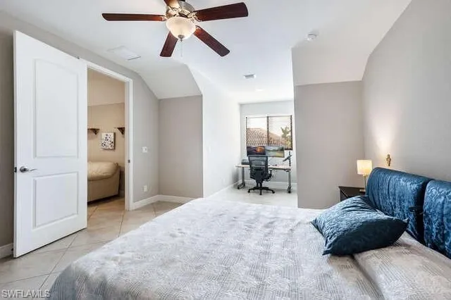 a bedroom with furniture and a window