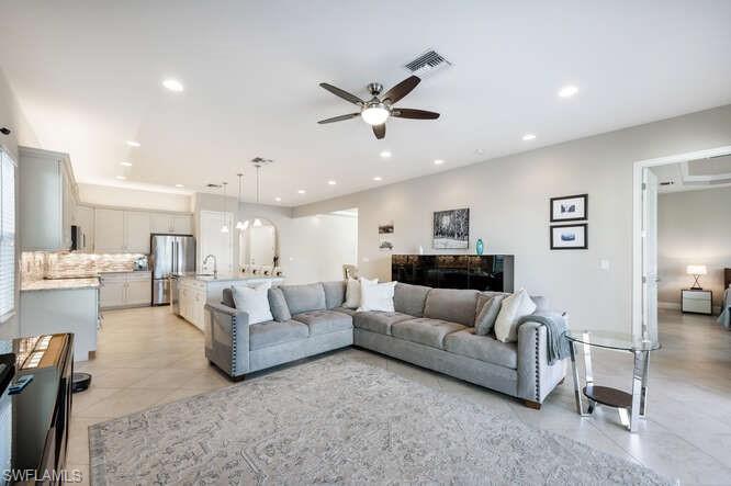 1641 Serrano Circle Naples, FL 34105 - Photo 9 of 50 a living room with furniture kitchen view and a chandelier