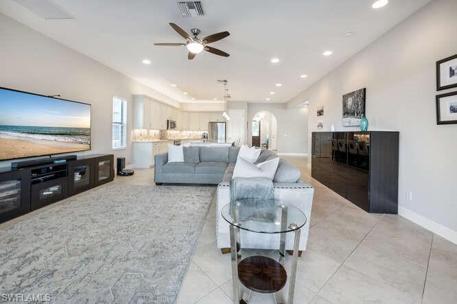 1641 Serrano Circle Naples, FL 34105 - Photo 10 of 50 a living room with furniture and a flat screen tv