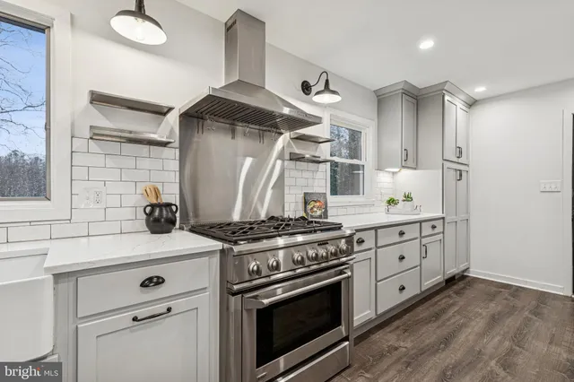 a large kitchen with stainless steel appliances kitchen island granite countertop a large counter top a sink stainless steel appliances and cabinets