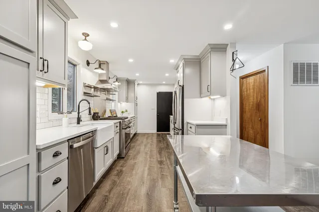 a kitchen with a refrigerator and a sink
