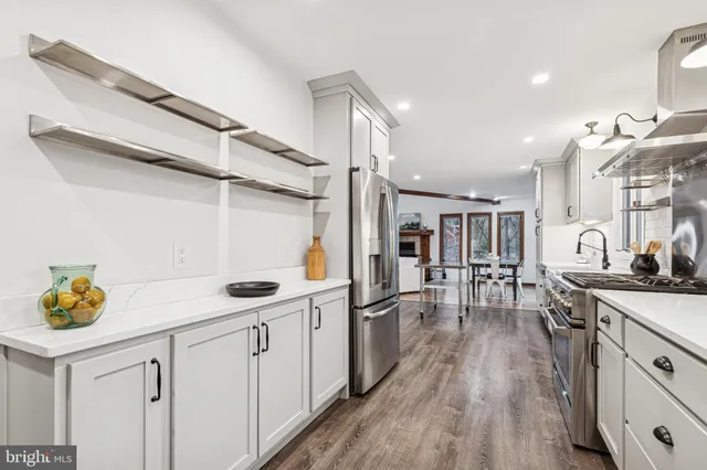 a kitchen with cabinets and wooden floor