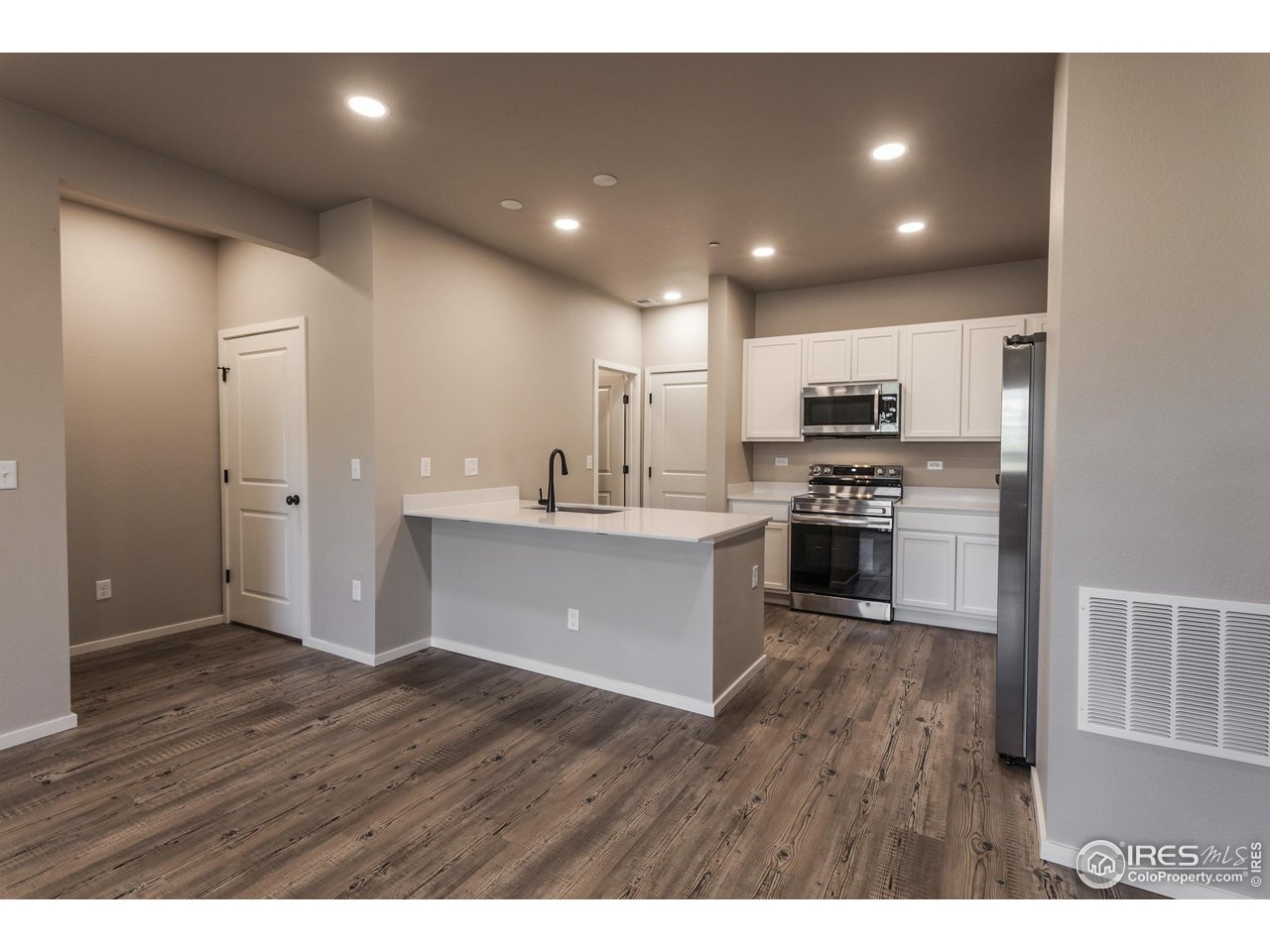 6721 4th St Road, Unit 5 Greeley, CO 80634 - Photo 10 of 38 KITCHEN W/ ISLAND