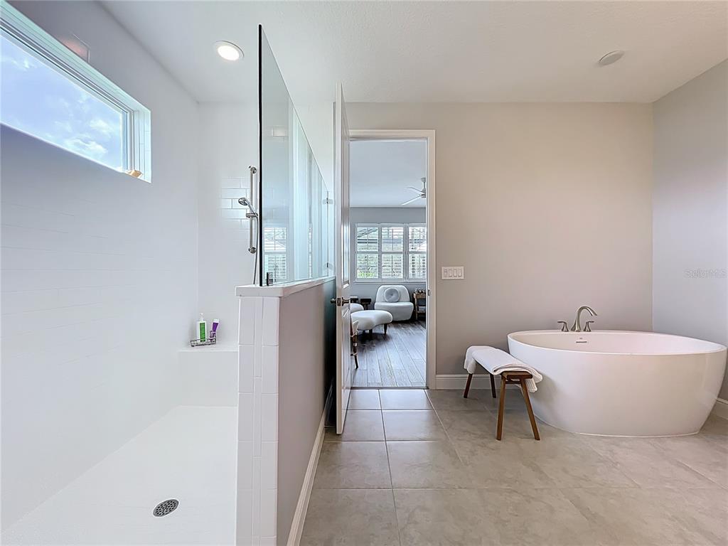 10220 Bay Lake Road Groveland, FL 34736 - Photo 31 of 67 a spacious bathroom with a double vanity sink and a mirror