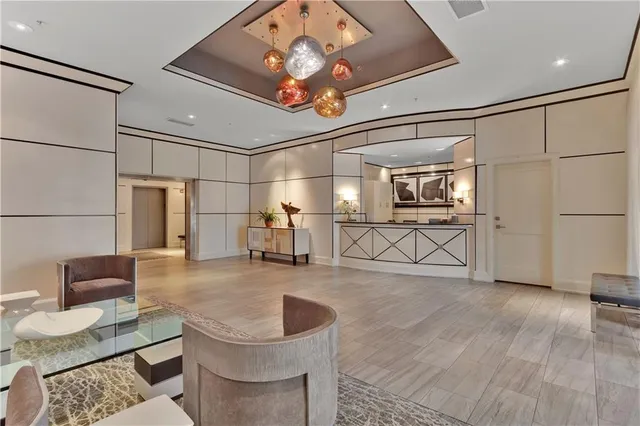 a living room with couches and kitchen view with wooden floor