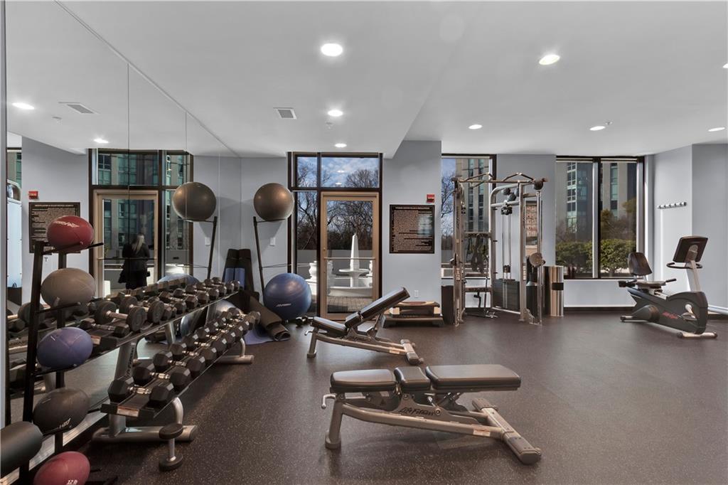 2828 Peachtree Road Northwest, Unit 1402 Atlanta, GA 30305 - Photo 14 of 23 a room with gym equipment and large windows