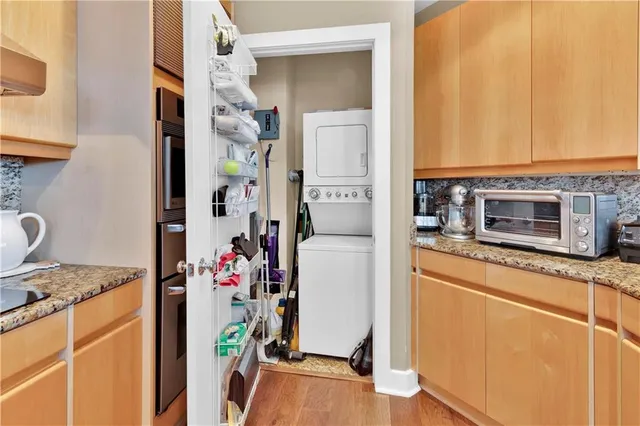 a kitchen with stainless steel appliances granite countertop a refrigerator and a stove top oven