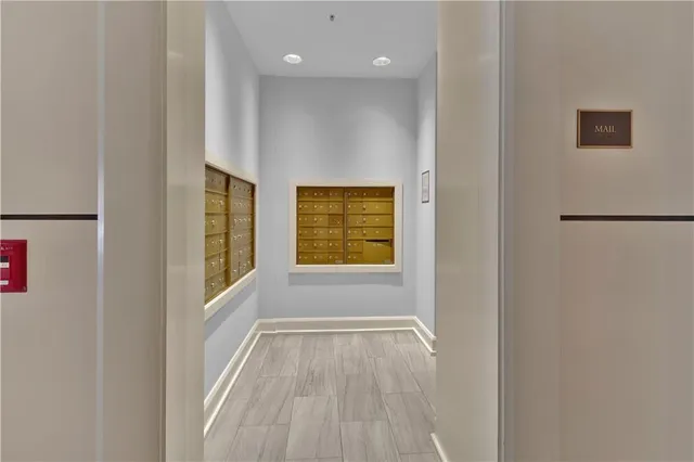 a view of an empty room with a window and a kitchen