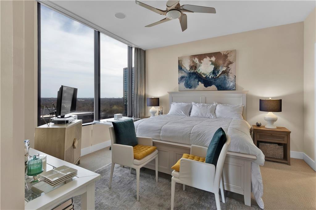 2828 Peachtree Road Northwest, Unit 1402 Atlanta, GA 30305 - Photo 21 of 23 a bedroom with a bed a large window and table