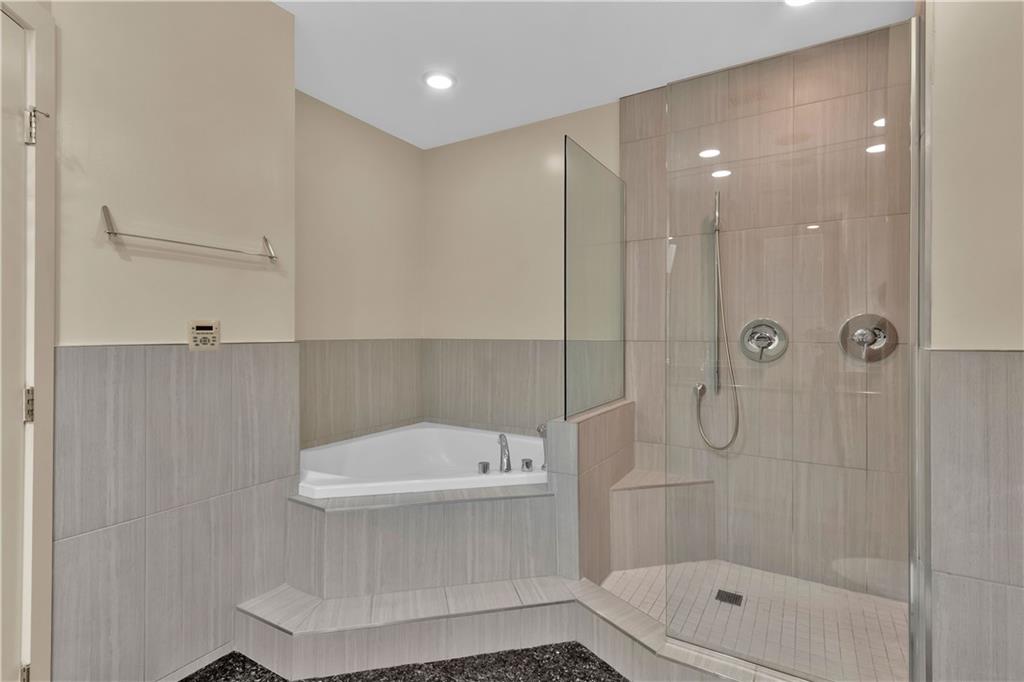 2828 Peachtree Road Northwest, Unit 1402 Atlanta, GA 30305 - Photo 22 of 23 a bathroom with a shower a toilet and a shower