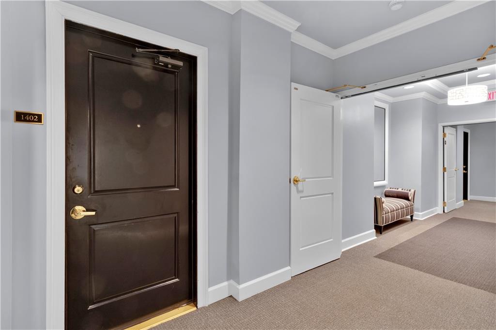 2828 Peachtree Road Northwest, Unit 1402 Atlanta, GA 30305 - Photo 4 of 23 a view of a livingroom and a bathroom with mirror