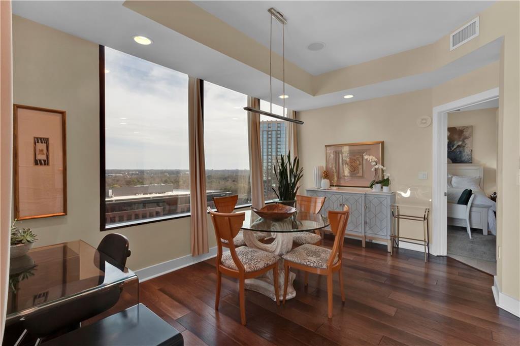2828 Peachtree Road Northwest, Unit 1402 Atlanta, GA 30305 - Photo 7 of 23 a dining room with furniture window wooden floor