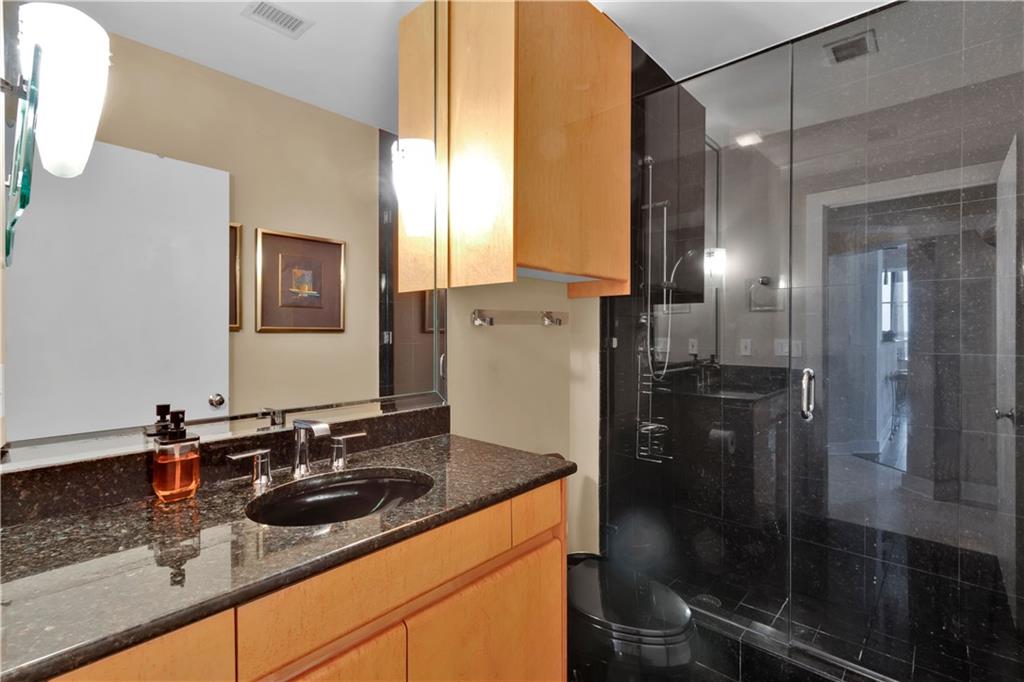 2828 Peachtree Road Northwest, Unit 1402 Atlanta, GA 30305 - Photo 8 of 23 a bathroom with a sink and mirror