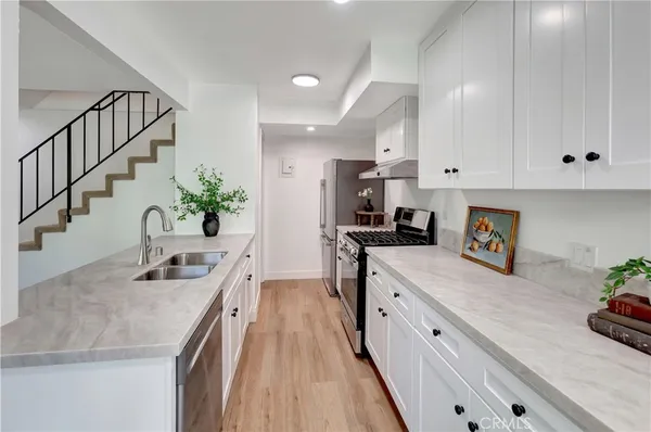 a kitchen with kitchen island granite countertop lots of counter top space and stainless steel appliances
