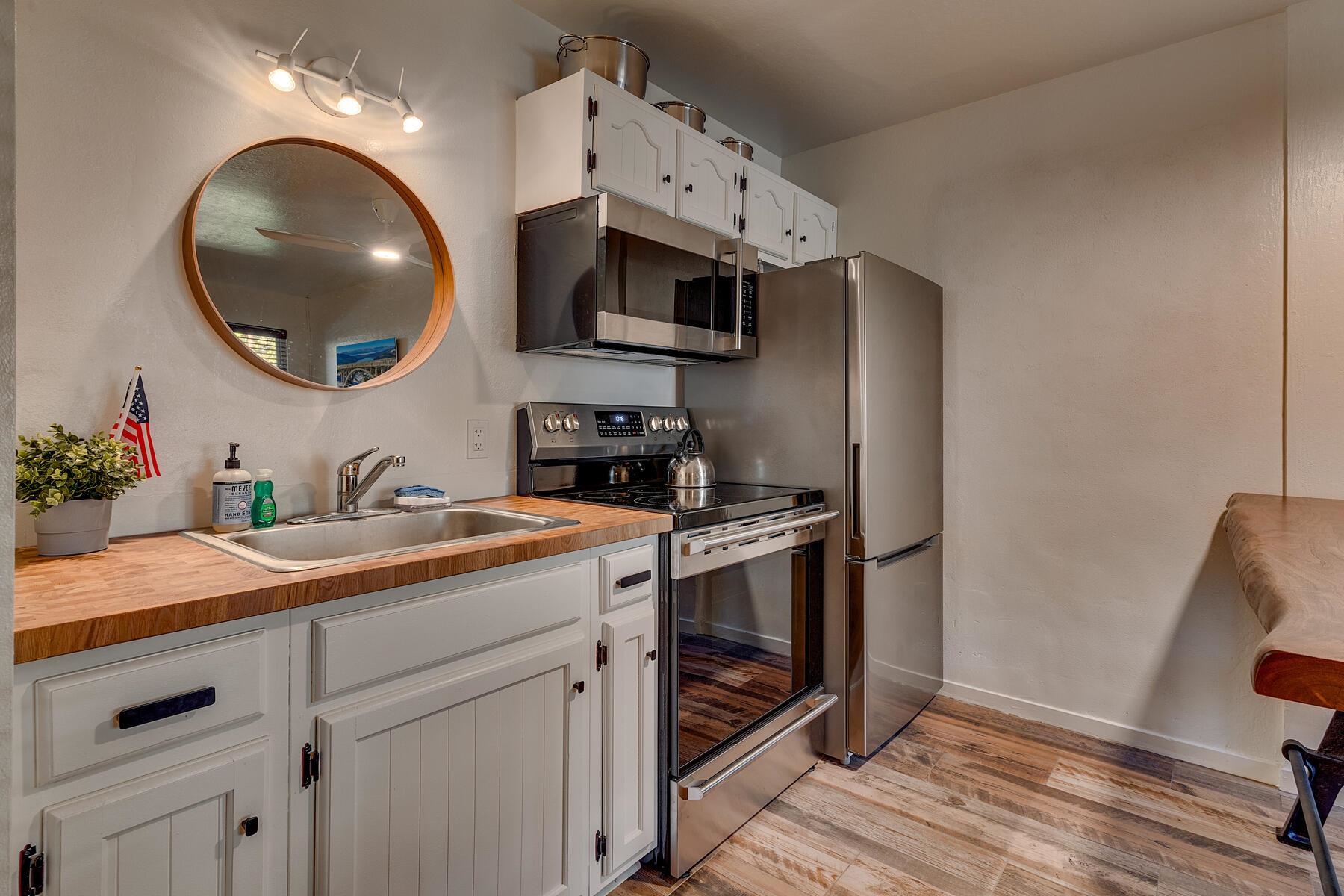 15775 Donner Pass Road, Unit 114 Truckee, CA 96161 - Photo 4 of 17 a kitchen with stainless steel appliances granite countertop a sink and a stove with wooden floor