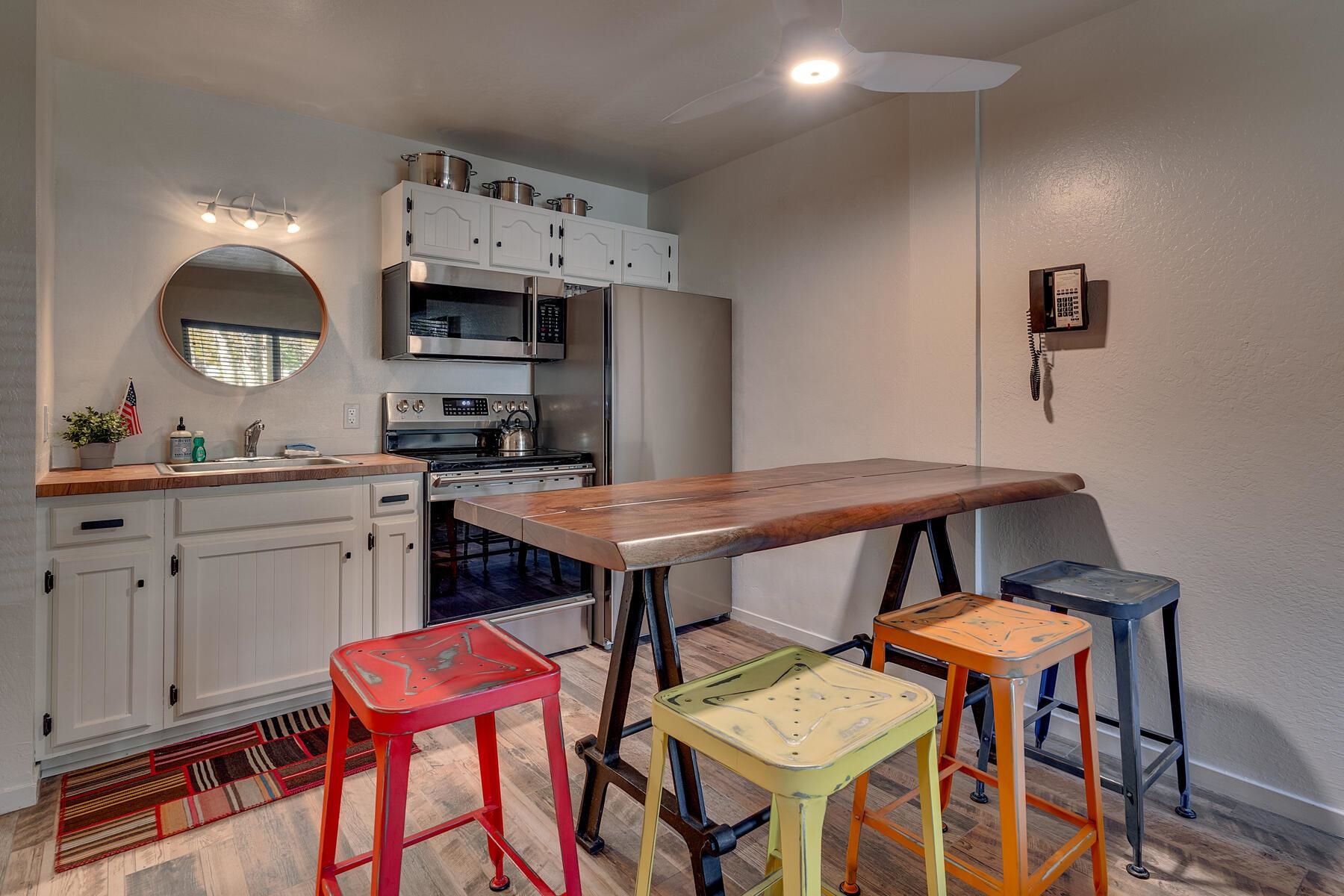 15775 Donner Pass Road, Unit 114 Truckee, CA 96161 - Photo 5 of 17 a kitchen with stainless steel appliances a dining table chairs and sink