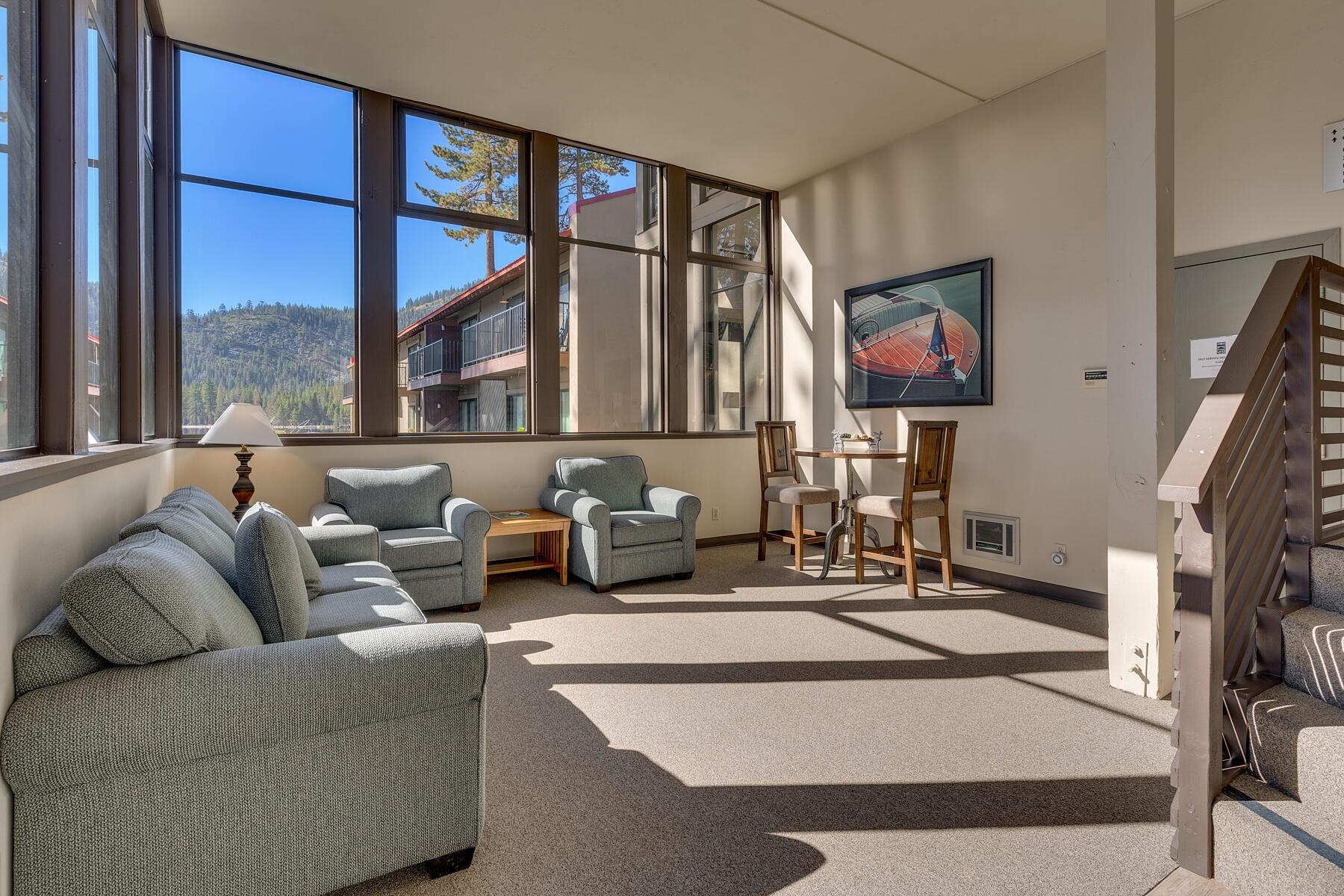 15775 Donner Pass Road, Unit 114 Truckee, CA 96161 - Photo 9 of 17 a living room with furniture a floor to ceiling window and a flat screen tv