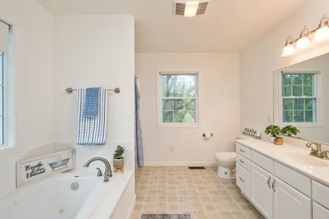 a bathroom with a sink a large mirror and a bathtub