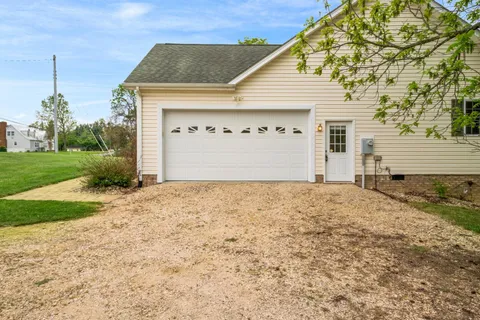 a view of a house with a yard and garage