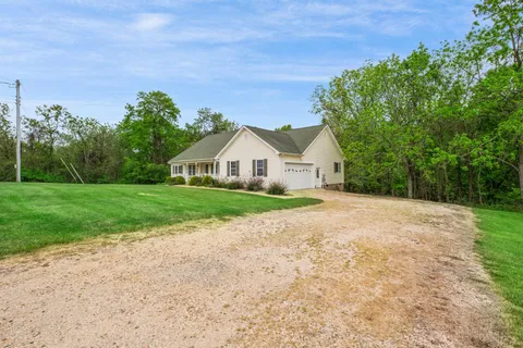 a view of house with backyard and garden