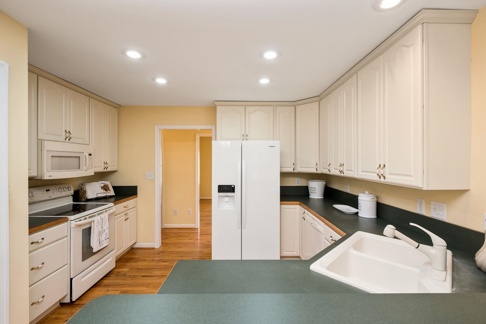1456 New Hope Road Staunton, VA 24401 - Photo 6 of 46 a kitchen with stainless steel appliances granite countertop a refrigerator sink and white cabinets