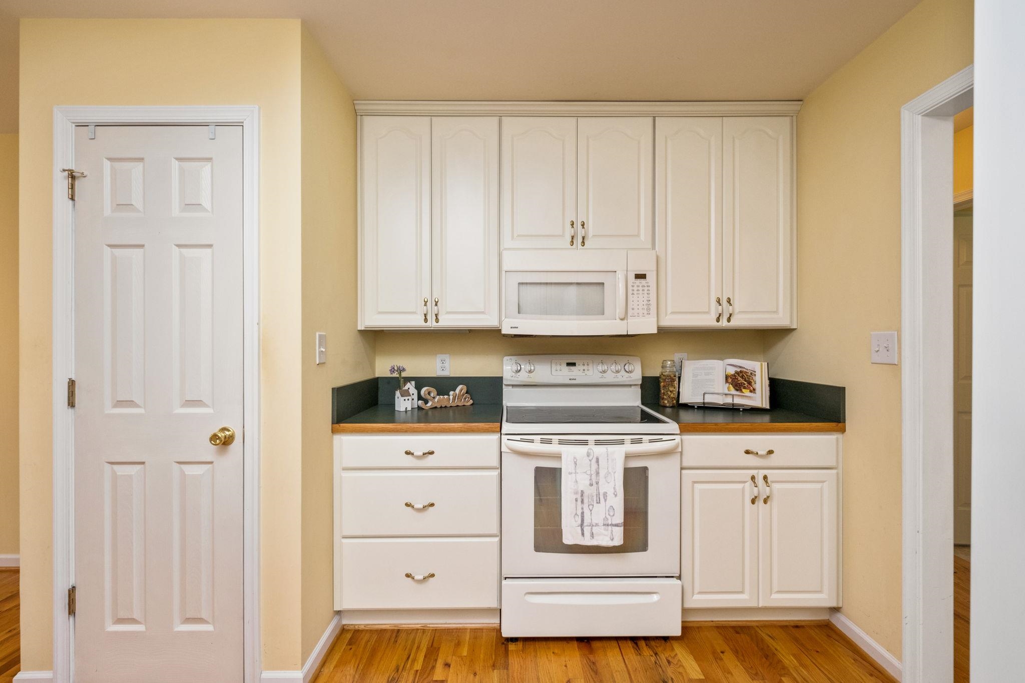 1456 New Hope Road Staunton, VA 24401 - Photo 7 of 46 a kitchen with white cabinets and appliances