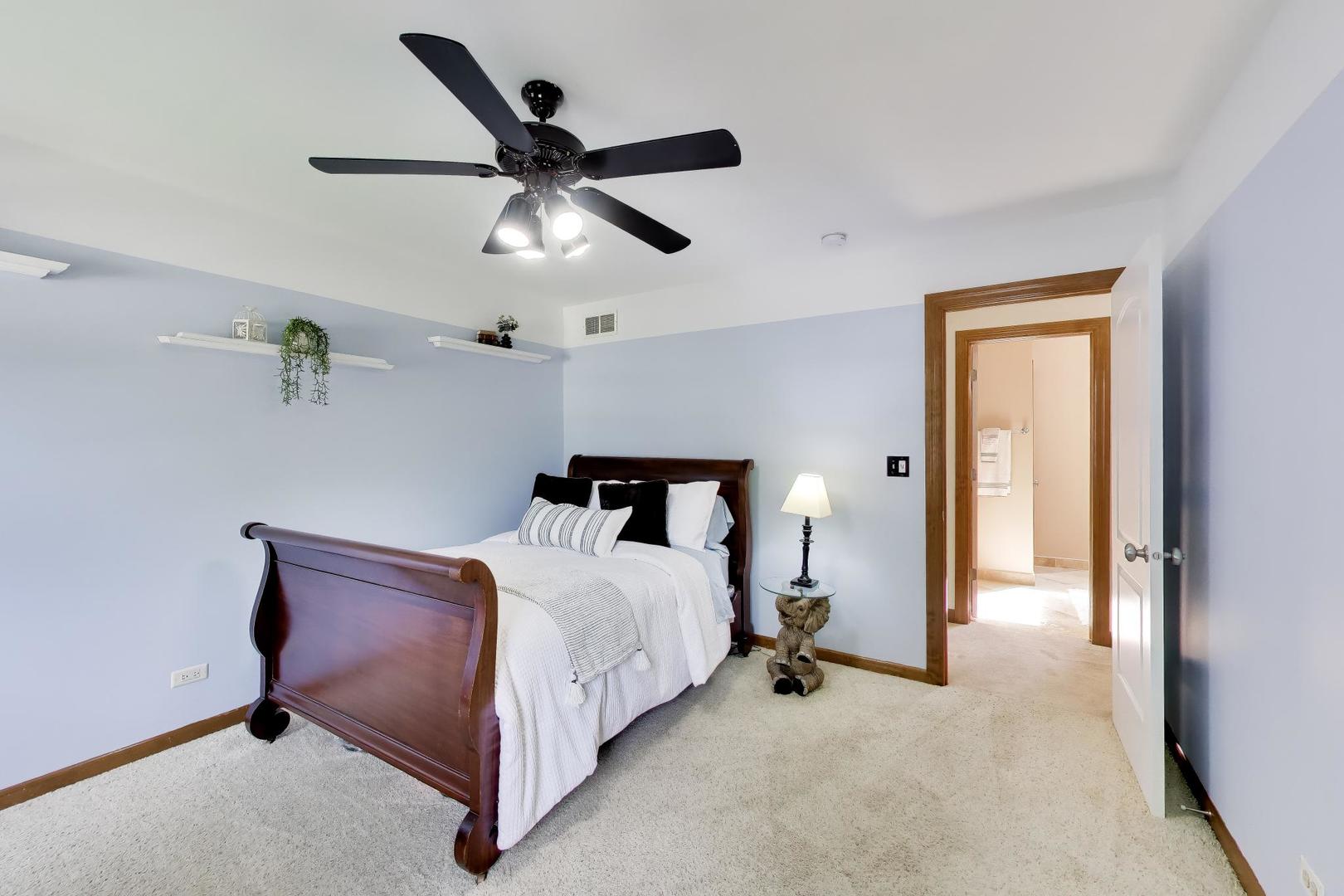 1528 Sequoia Road Naperville, IL 60540 - Photo 18 of 34 a bed room with a bed and a ceiling fan