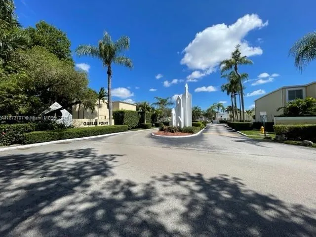 a view of a house with a yard and a garage
