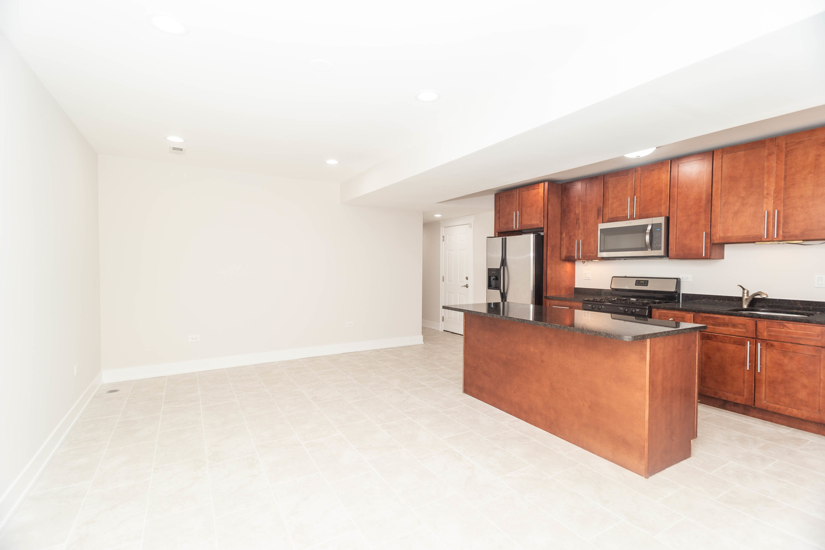 5444 North Winthrop Avenue, Unit GS Chicago, IL 60640 - Photo 5 of 18 a large kitchen with stainless steel appliances granite countertop a stove top oven a sink and dishwasher