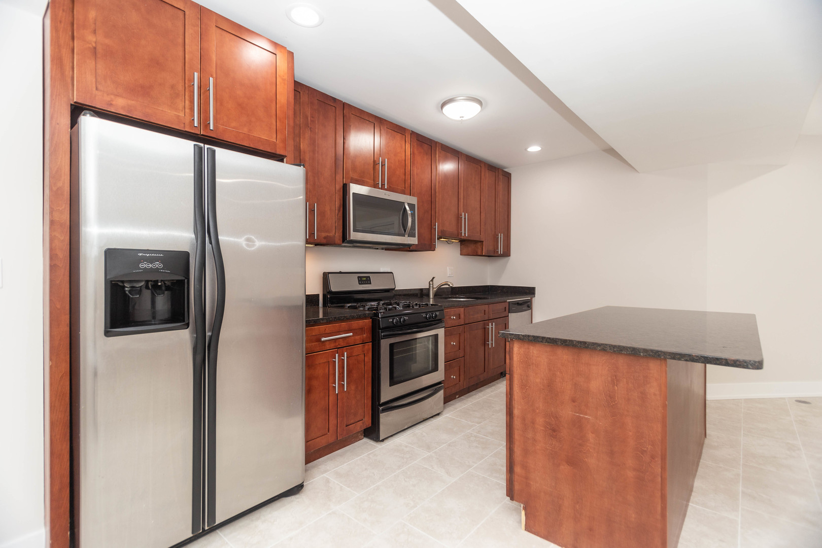 5444 North Winthrop Avenue, Unit GS Chicago, IL 60640 - Photo 6 of 18 a kitchen with stainless steel appliances granite countertop a refrigerator and a stove top oven