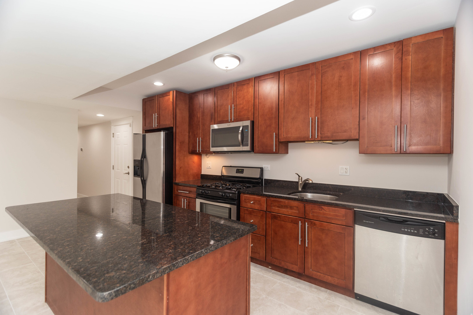 5444 North Winthrop Avenue, Unit GS Chicago, IL 60640 - Photo 7 of 18 a kitchen with stainless steel appliances granite countertop a sink a stove counter space and cabinets