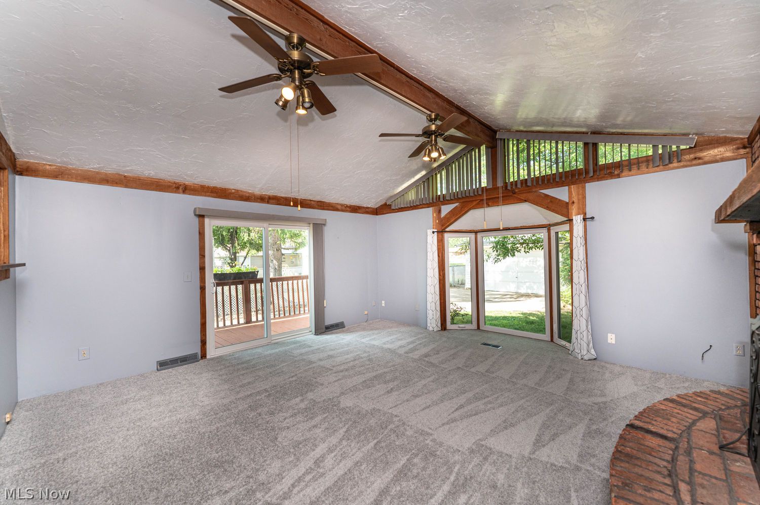 916 Center Road Eastlake, OH 44095 - Photo 14 of 39 Enormous great room with new carpeting, classic look bay window, slider to one of two newer decks and french door entrance from the kitchen