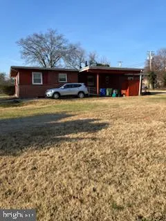 a front view of a house with a yard and mountain view