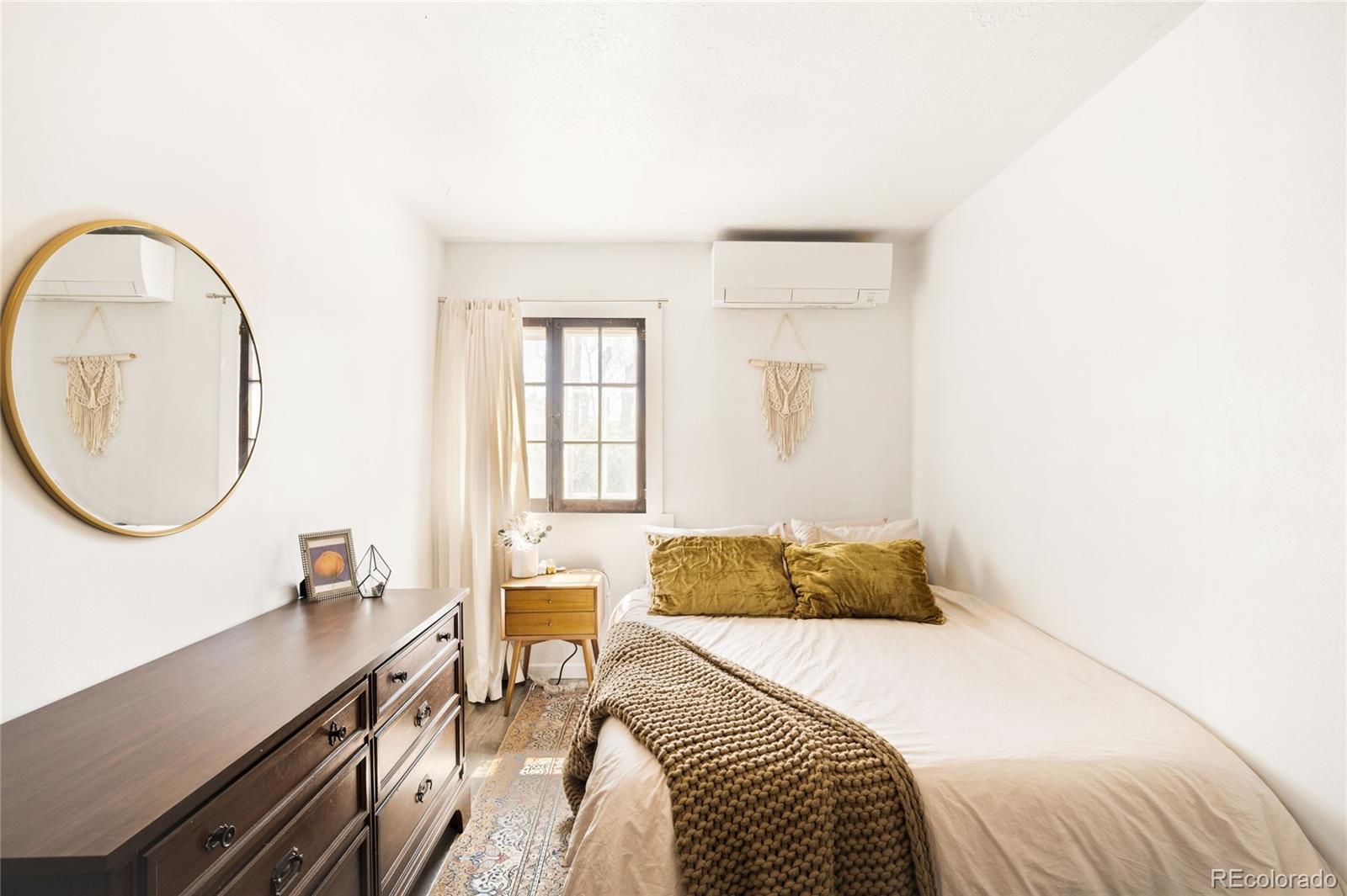 6800 Monaco Street Commerce City, CO 80022 - Photo 14 of 29 a bedroom with a bed and a large mirror next to a window