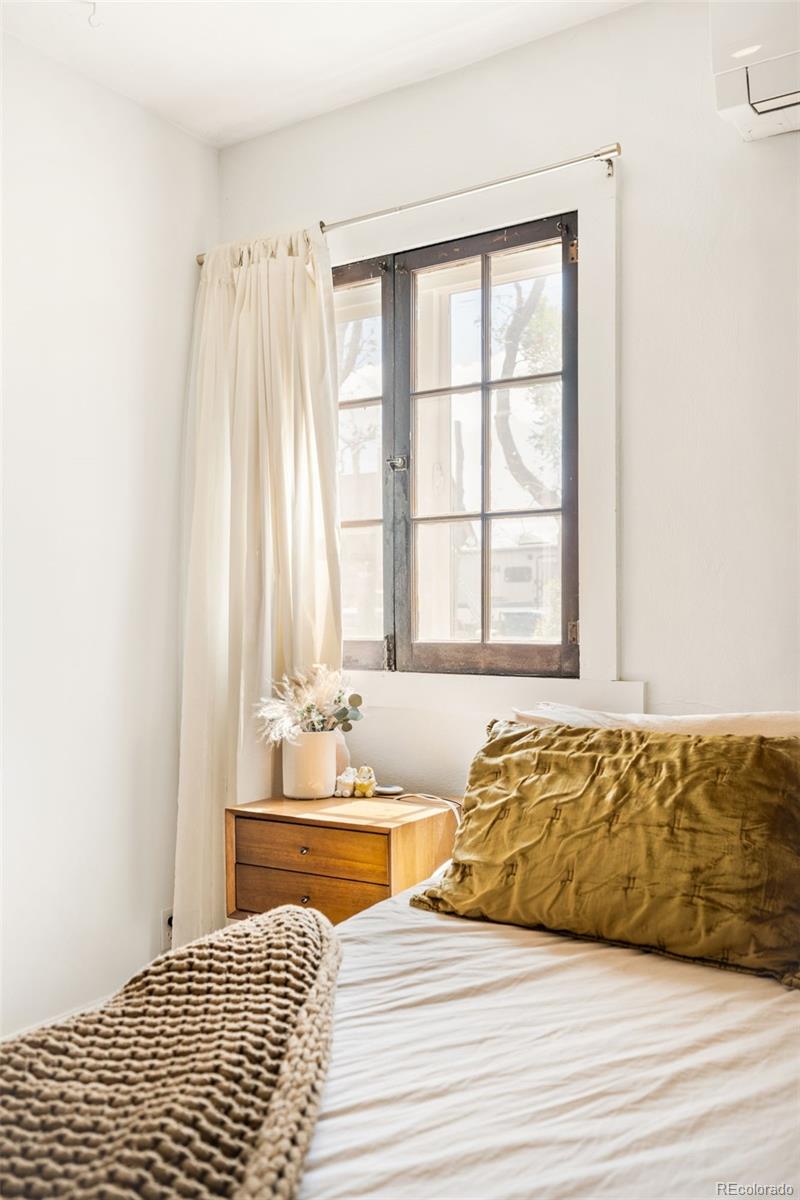 6800 Monaco Street Commerce City, CO 80022 - Photo 15 of 29 a living room with a bed and next to a window