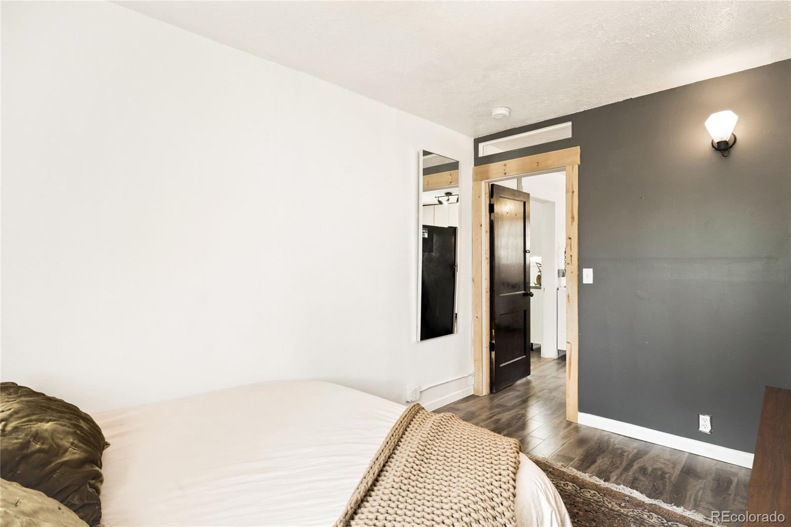 6800 Monaco Street Commerce City, CO 80022 - Photo 16 of 29 a bedroom with a bed and a view of bathroom