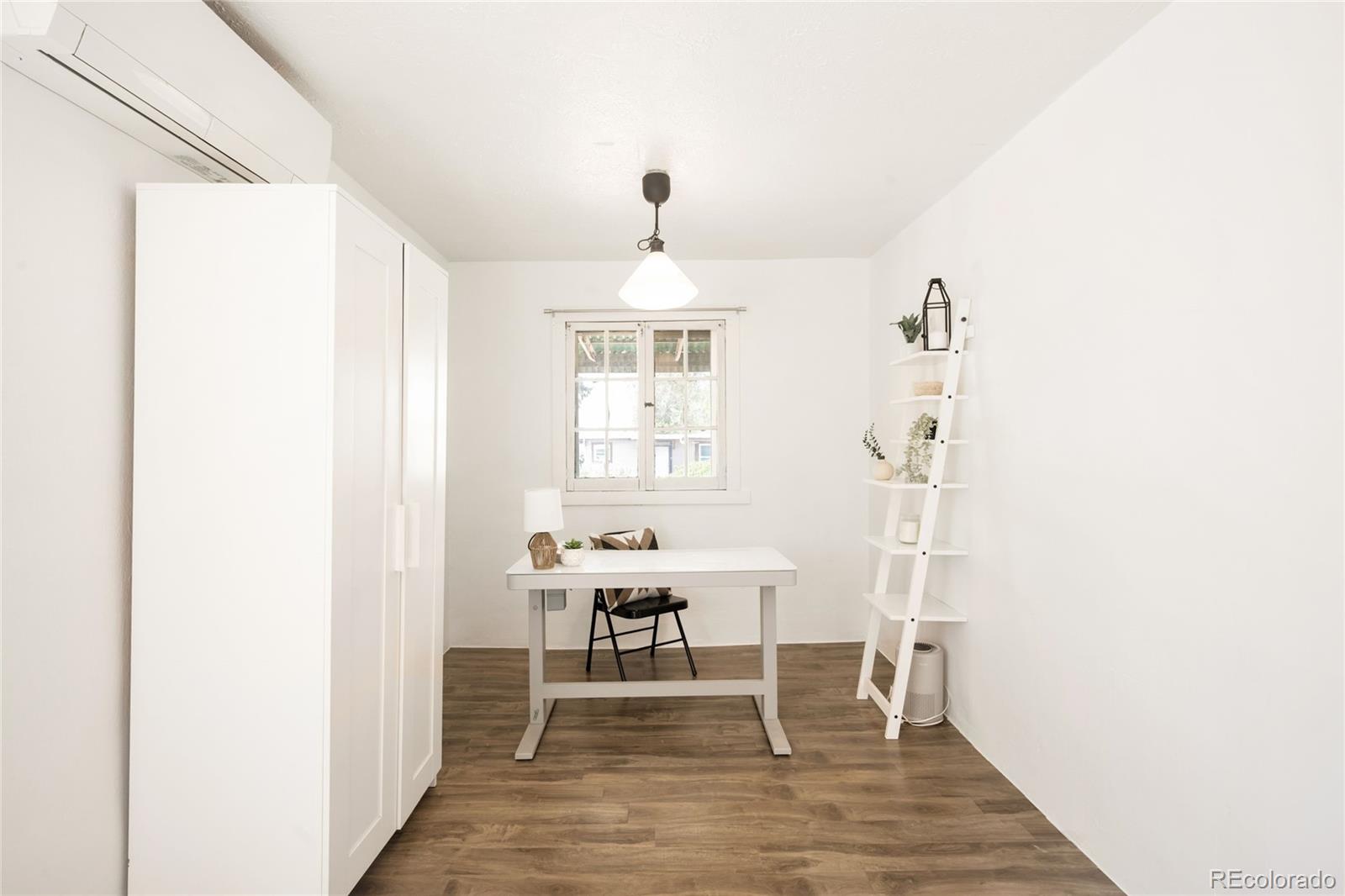 6800 Monaco Street Commerce City, CO 80022 - Photo 17 of 29 a living room with furniture and a window
