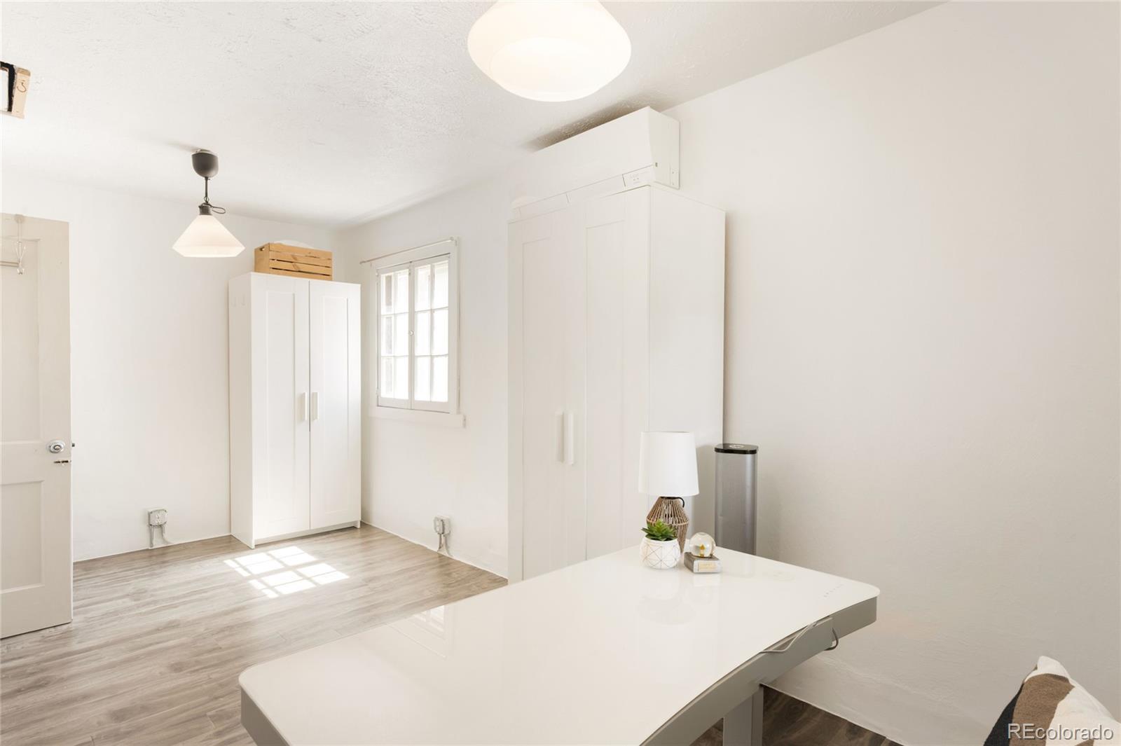 6800 Monaco Street Commerce City, CO 80022 - Photo 18 of 29 a kitchen with a sink cabinets and wooden floor