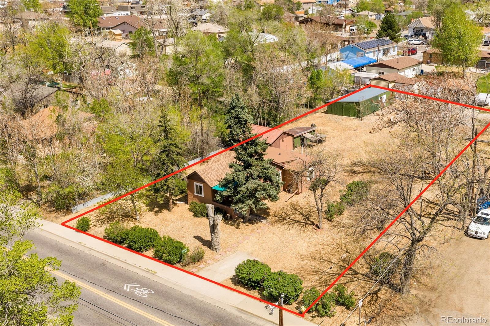 6800 Monaco Street Commerce City, CO 80022 - Photo 26 of 29 a view of a small yard with large trees